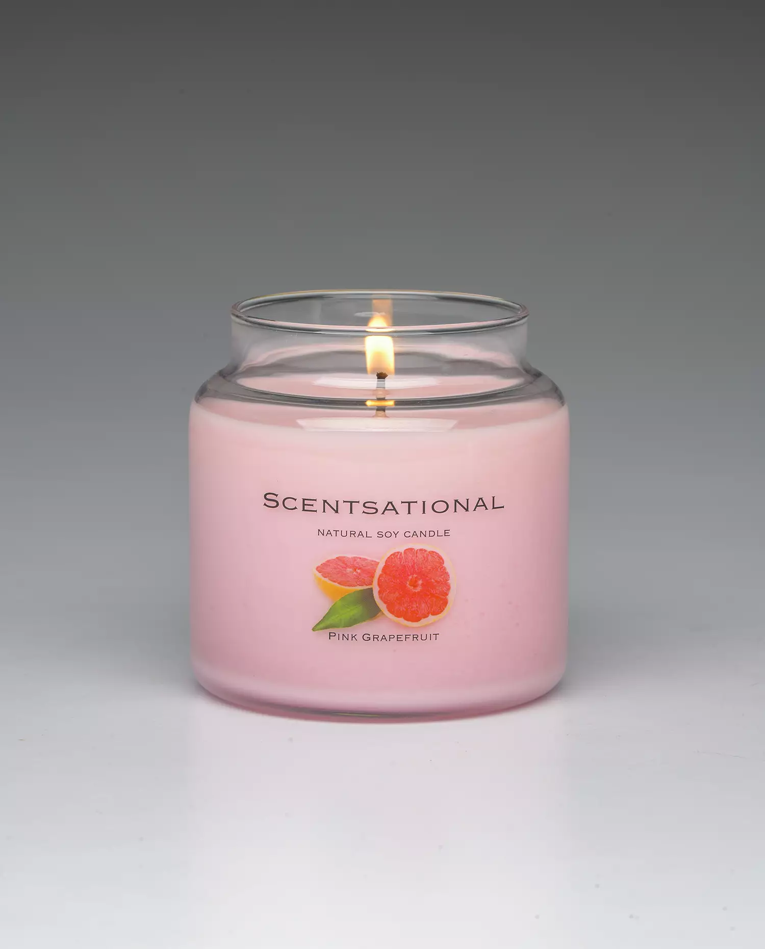 Pink Grapefruit 19oz scented candle burning