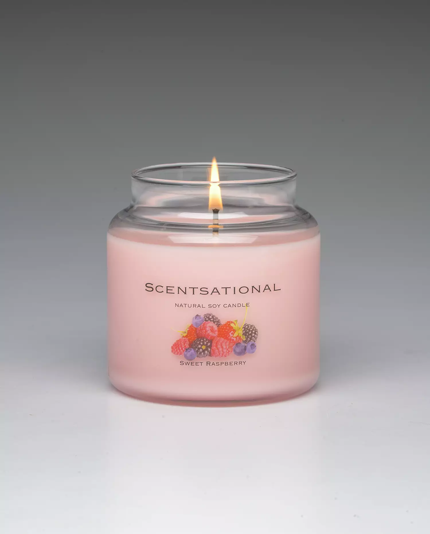 Sweet Raspberry 19oz Scented Candle burning